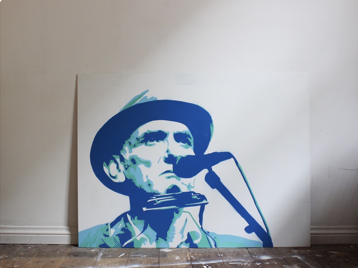 Blue stencil portrait of a harmonica player