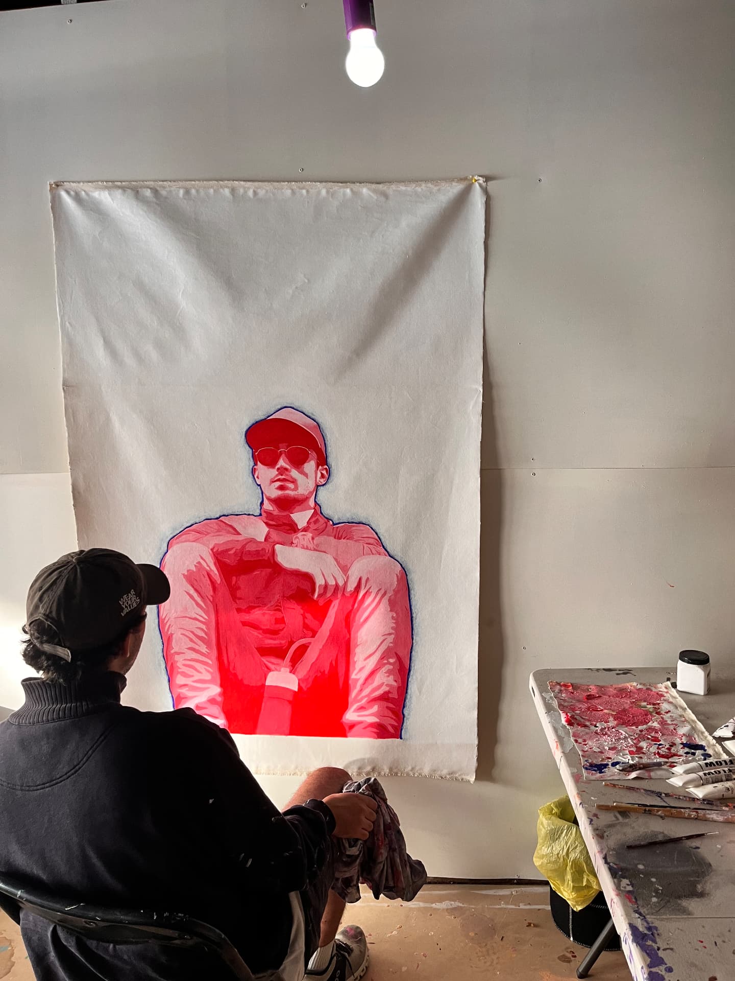 WILBUR with a large red figure painting in the studio